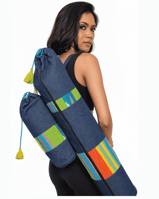 Blue denim yoga mat bag carried by a woman with colourful patchwork details
