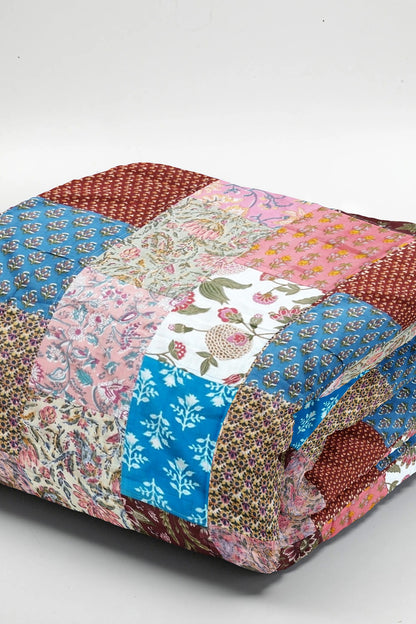 Colorful ethnic print patchwork bed quilt by Bunko Junko, showcasing vibrant and artistic designs with a blend of ethnic patterns. Ideal for adding a unique touch to your bedroom decor.