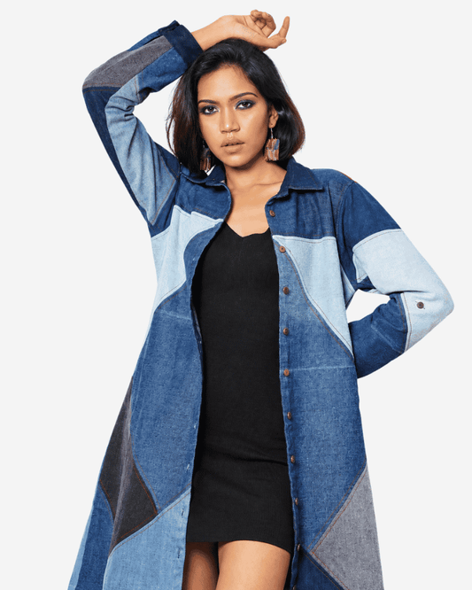 Woman wearing a blue geometric patchwork denim long jacket dress over a black outfit, front view, Bunko Junko.
