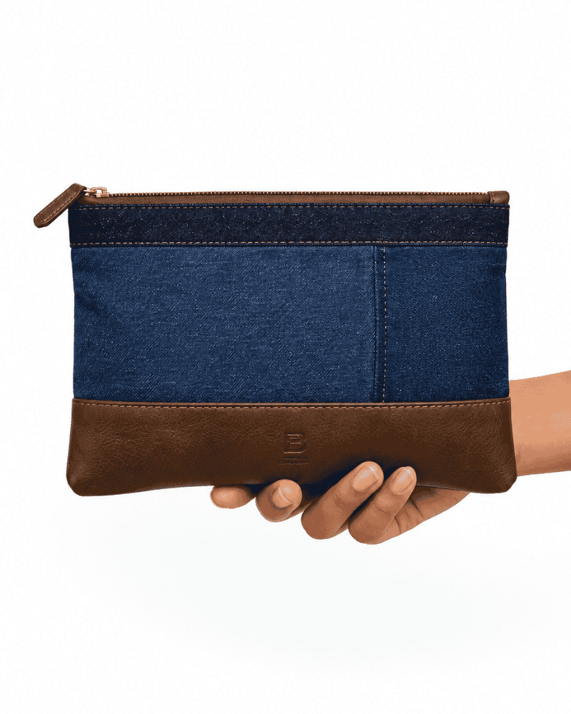 Blue and dark rectangular patchwork pouch held in hand
