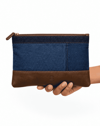 Blue and dark rectangular patchwork pouch held in hand
