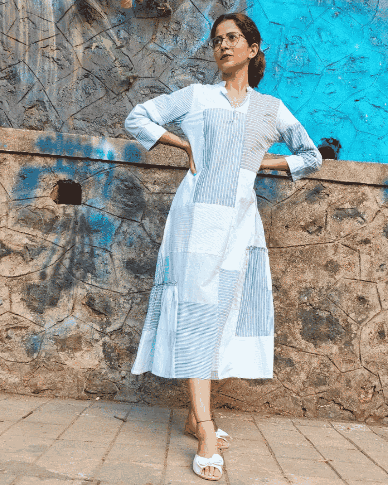 Woman wearing a light blue Fabric Finesse dress in an outdoor setting
