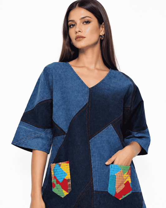 Woman wearing a blue and navy patchwork denim top with a V-neckline, wide sleeves and colourful front pockets, Bunko Junko.

