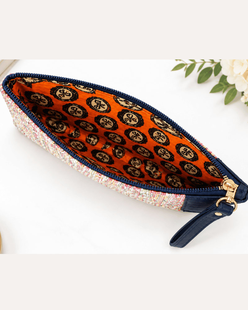 Rang Woven Clutch showing its multicolour woven textile pattern and navy blue detailing
