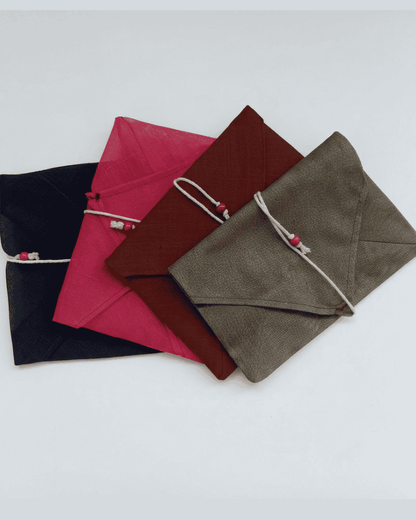 Assorted fabric envelopes in burgundy, pink and brown