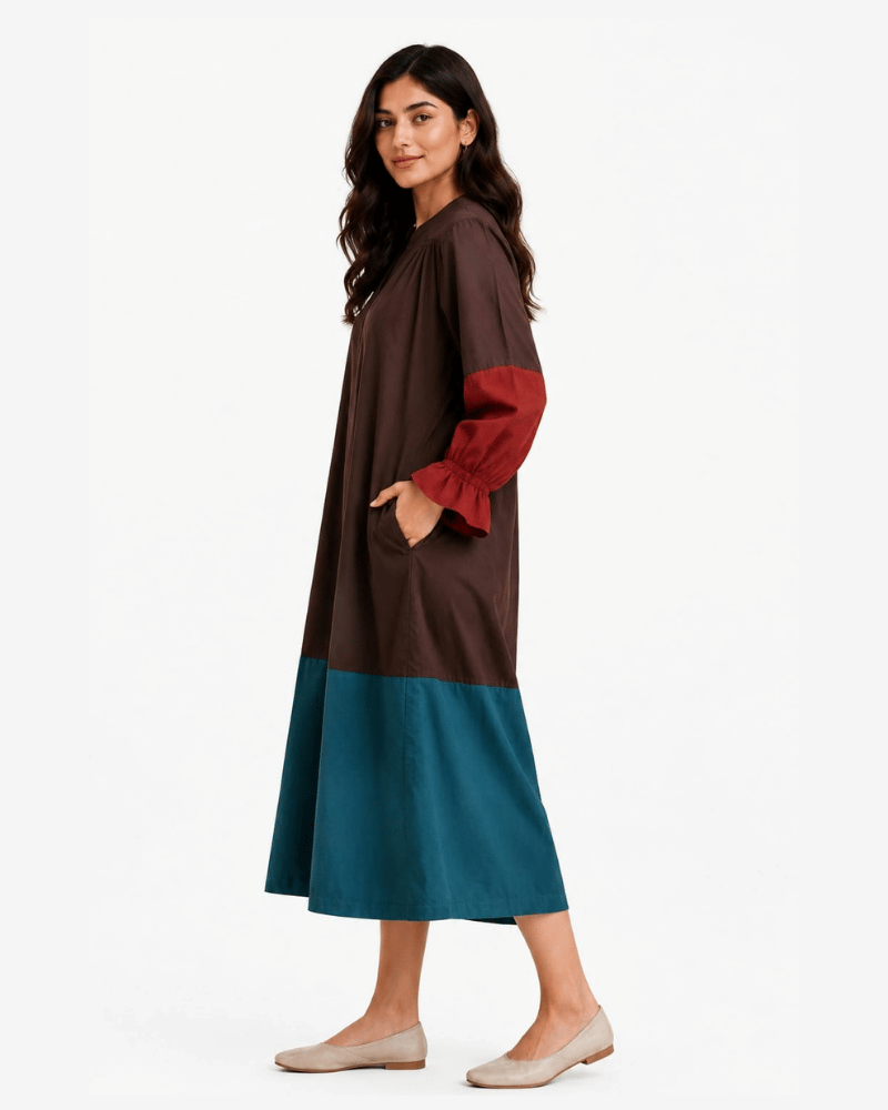 Front view of brown and teal colour block dress with contrasting rust-red sleeves