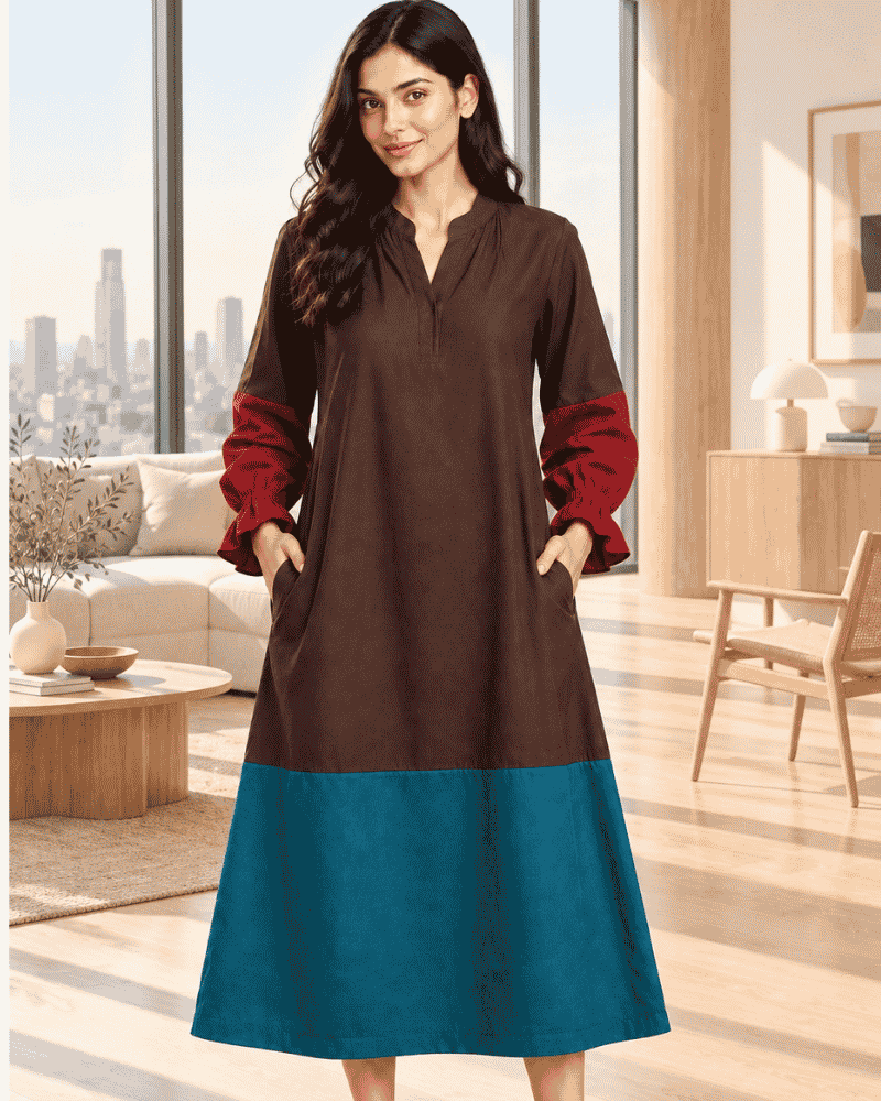 Woman wearing a brown and teal colour block dress with rust-red sleeves
