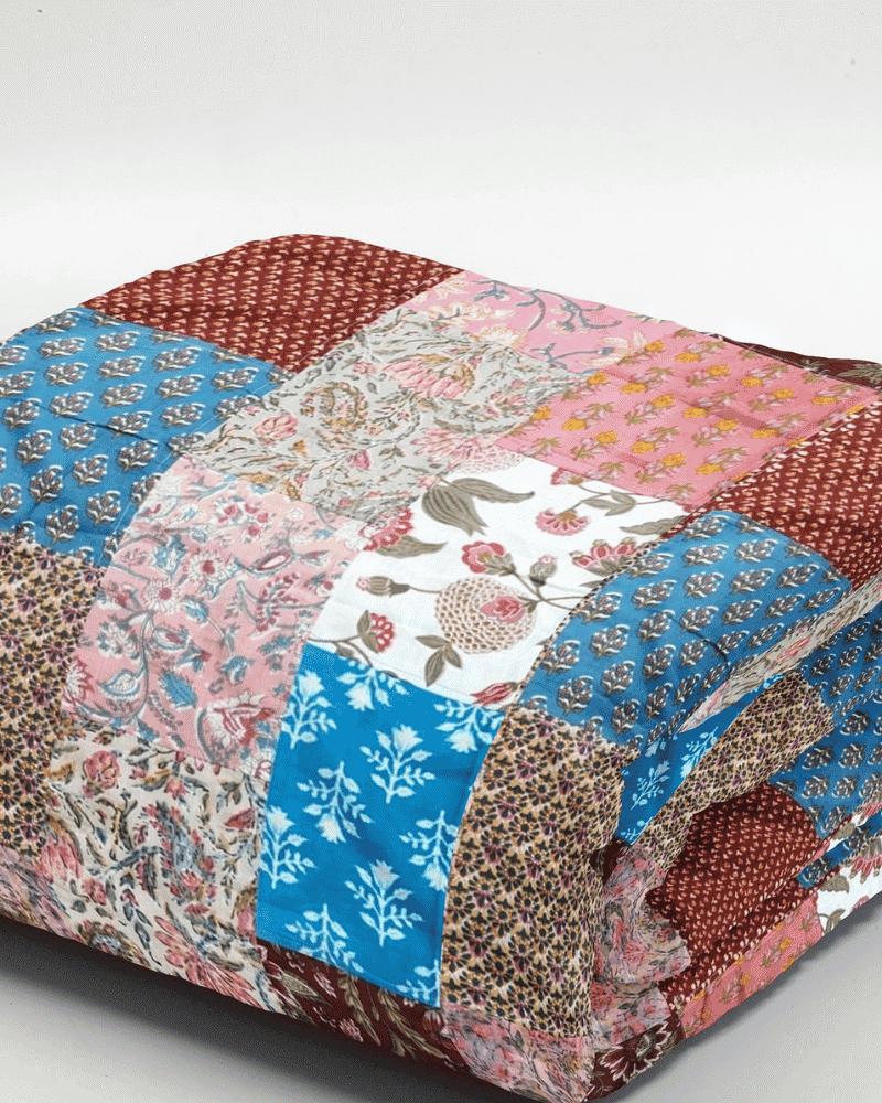 Close up of colourful patchwork detail on Ethnic Charm bed spread