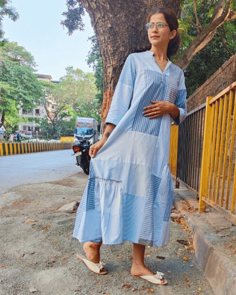 Woman wearing a light blue Fabric Finesse dress posing outdoors