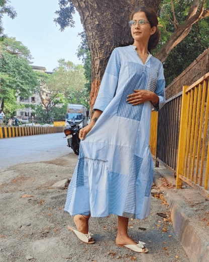 Woman wearing a light blue Fabric Finesse dress posing outdoors