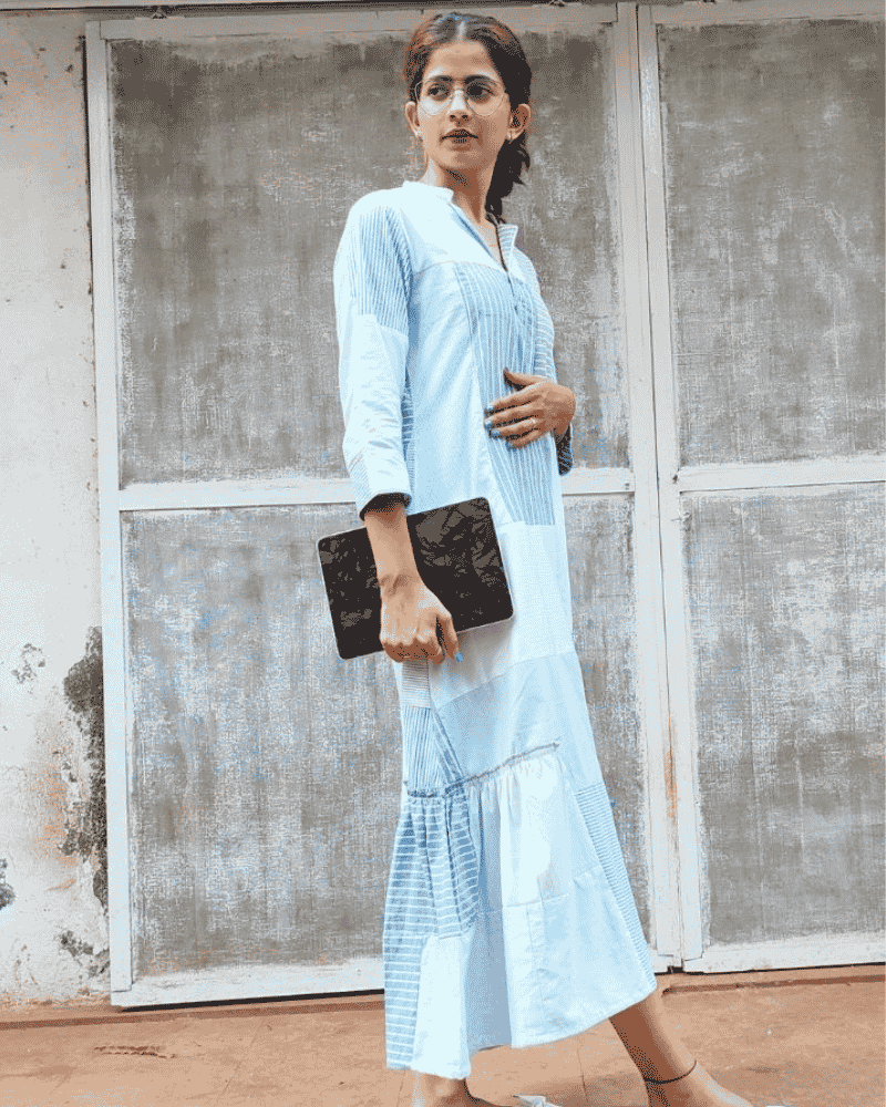 Woman wearing a light blue Fabric Finesse dress standing outdoors
