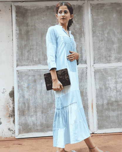 Woman wearing a light blue Fabric Finesse dress standing outdoors
