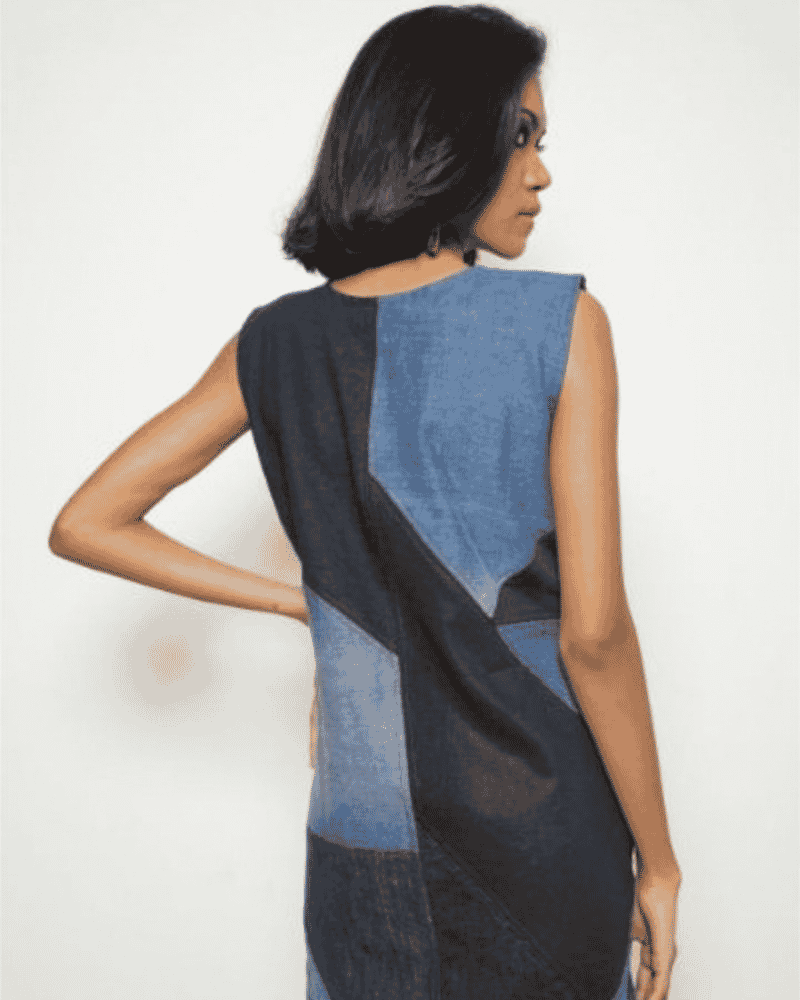 Back view of a woman wearing a blue patchwork denim dress