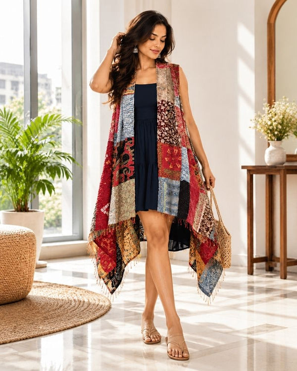Woman wearing a multicolor Kantha patchwork shrug made from reclaimed textile pieces