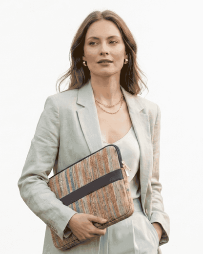 Woman carrying a Kora laptop sleeve made from upcycled textile
