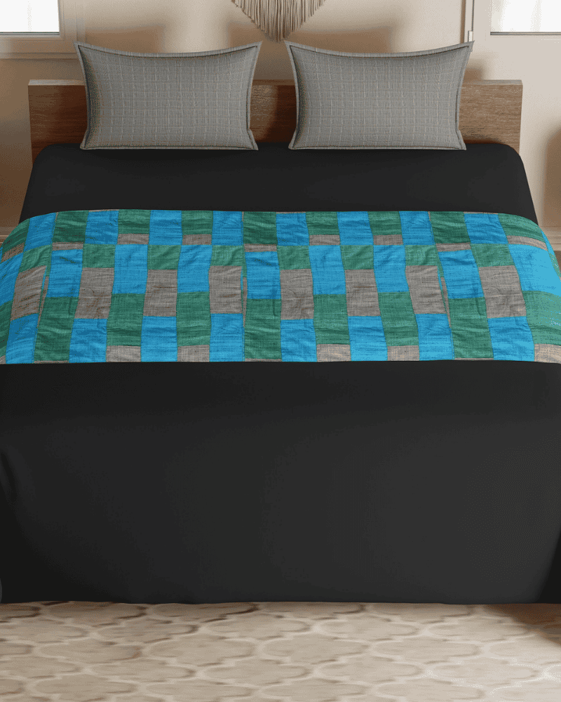 Patch Fusion upcycled bed runner styled on a blue bed