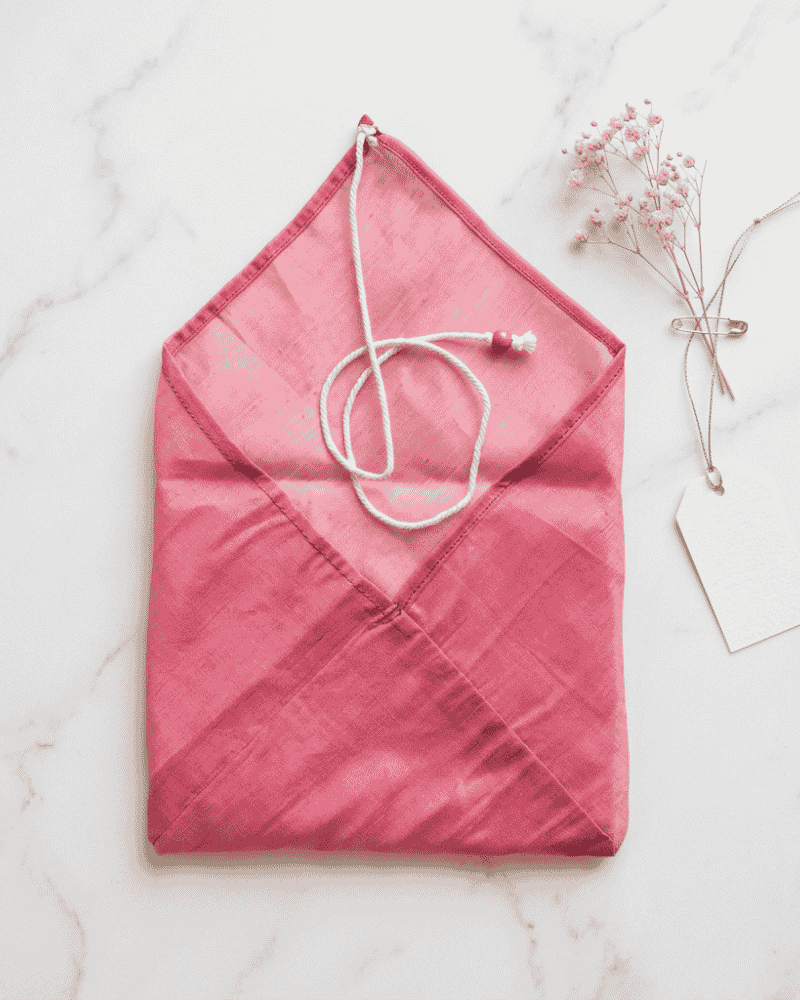 Pink fabric envelope with a matching cord closure