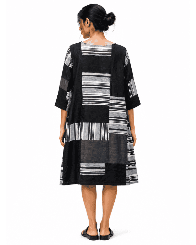 Back view of Riva black and white patchwork dress with mixed striped panels
