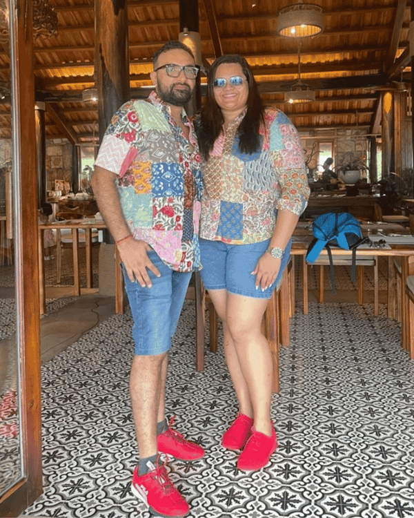 Couple wearing matching twinning trend upcycled shirts.