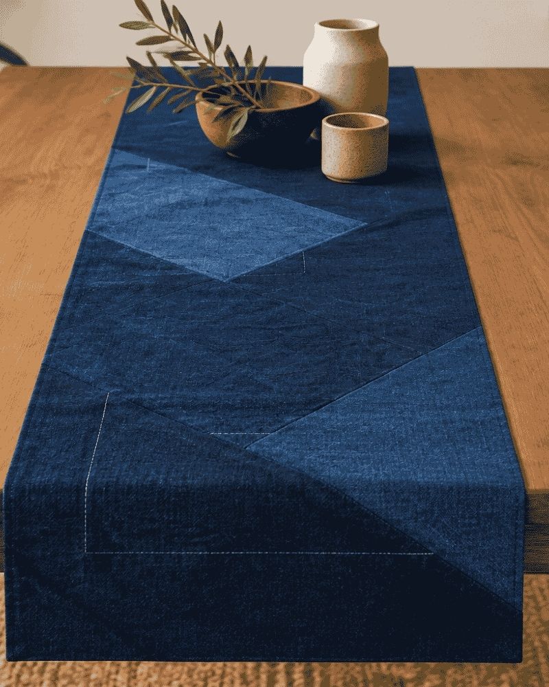 Dark and light blue geometric patchwork table runner styled with ceramics on a wooden table, Bunko Junko.