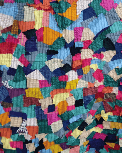 Blue and multicolour upcycled textile panel with geometric fabric pieces.
