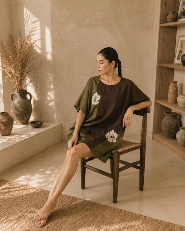 Woman wearing an olive and chocolate brown Vanya tunic dress with floral embroidery