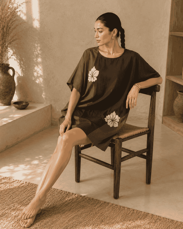 Woman wearing an olive and chocolate brown Vanya tunic dress with floral embroidery
