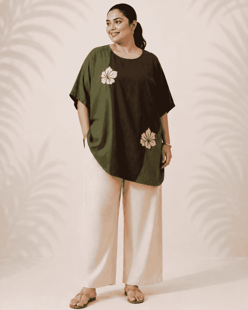 Woman styling an olive and brown Vanya tunic dress with floral embroidery