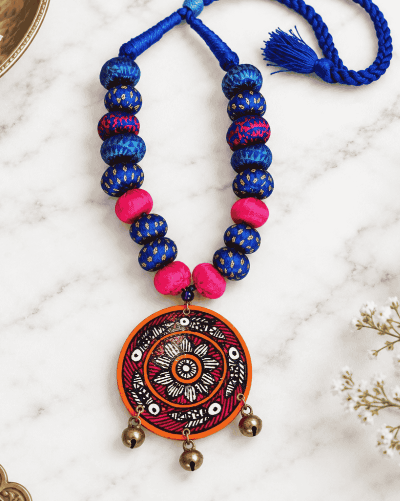 Handcrafted Wearable Art Necklace featuring blue beads and a circular artistic pendant.
