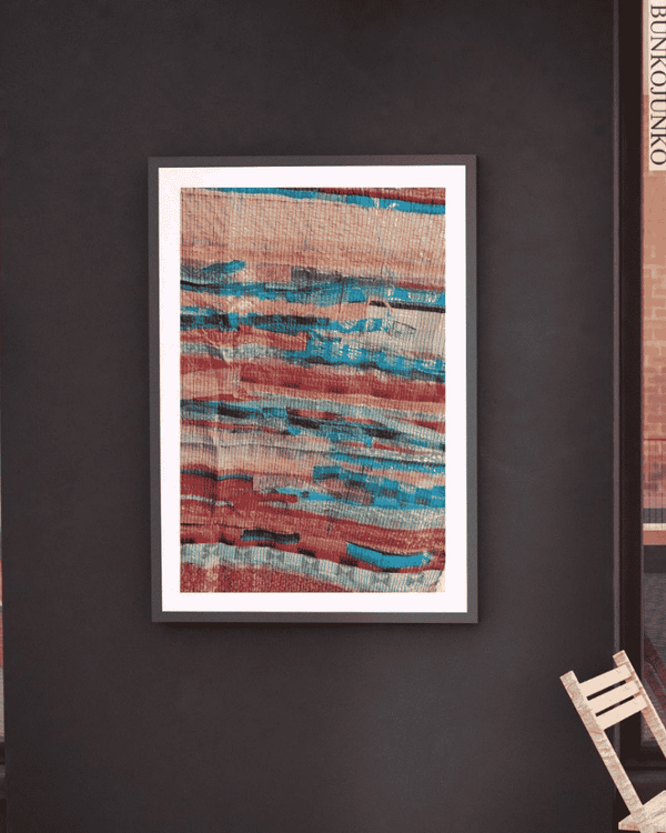 Woven Stories upcycled textile wall art displayed on a dark wall